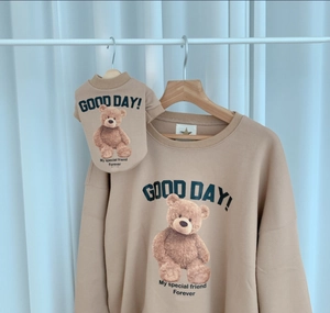 Detail of matching pet and owner fleece sweatshirts with teddy bear print and text
