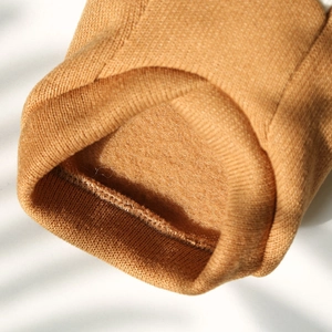 Close-up of knit pet sweater featuring warm fleece lining and ribbed cuff details