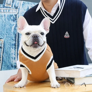 Close-up of brown V-neck knit dog vest with college style stripe detailing on collar