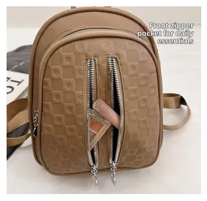 Macro detail of brown leather backpack front zipper pockets with cosmetic storage