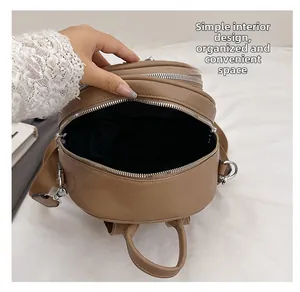 Detail view of khaki leather backpack showing simple interior design and neat space
