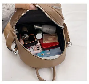 Interior view of soft leather backpack showing large capacity and zipper compartments