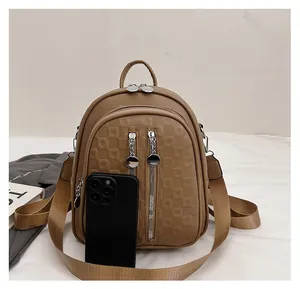 Detailed view of the brown faux leather backpack featuring checkered texture and multiple pockets