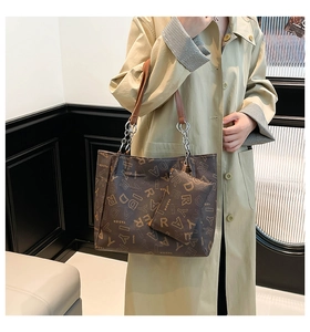 Detail of dark brown tote bag with letter print and matching coin purse accessory
