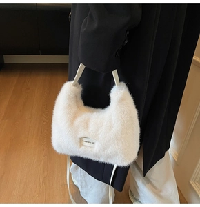 Detail of white faux fur tote bag featuring Love Every Day text label and soft texture