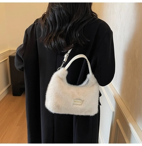 Detail of off-white plush shoulder bag with leather strap and love every day logo