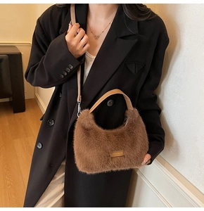 Detail of plush brown tote bag with leather handle and love every day stitched label