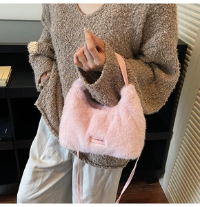 Close-up of pink faux rabbit fur handbag showing soft texture and Love Every Day label