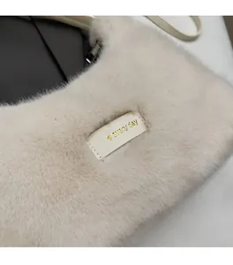 Detail of soft cream faux fur shoulder bag featuring love every day leather patch