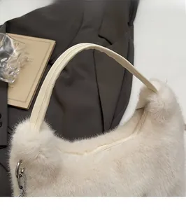 Detail of soft white faux fur texture and smooth cream handle on stylish tote bag