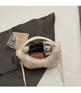 Macro detail of spacious white plush bag interior holding phone and wallet