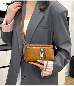 Brown faux suede crossbody bag with metallic robot charm and silver zipper detail