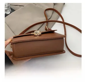 Detailed close-up of brown leather bag showing durable base stitching and textured finish
