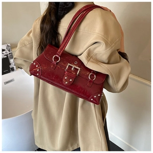 Deep red patent leather underarm bag featuring silver rivets and metal buckle detail