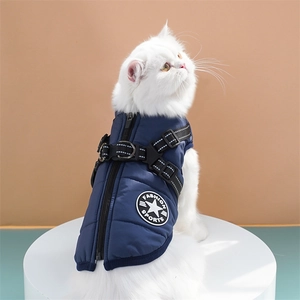 Detail of navy blue quilted pet vest with zipper and metal D-ring for leash attachment