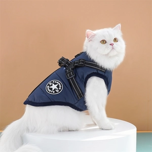 Detail of dark blue warm pet vest featuring star logo and integrated harness on a cat