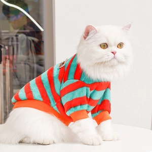 Close-up of a striped knit pet sweater with soft texture and cartoon patch on a white cat