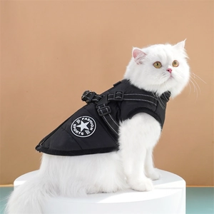 Detail of waterproof black pet winter vest with adjustable harness on a white cat