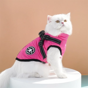 Pink dog harness vest with adjustable buckle and D-ring on a white long-haired cat
