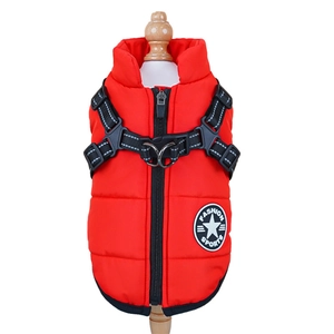 Detail of red padded dog vest with integrated harness and dual D-rings on a wooden stand