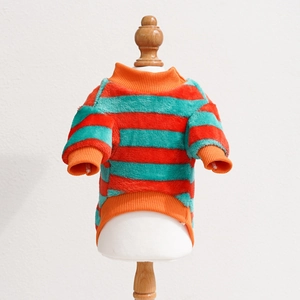 Close-up of pet striped fleece sweater with orange and teal ribbed edges and soft texture