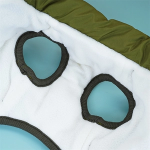 Detail of warm dog vest showing army green outer shell and soft white fleece lining