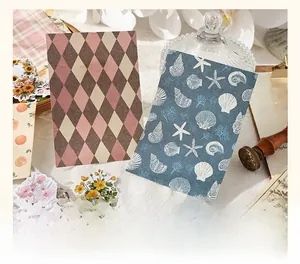 Close-up of vintage aesthetic stickers with botanical and seashell patterns on lace