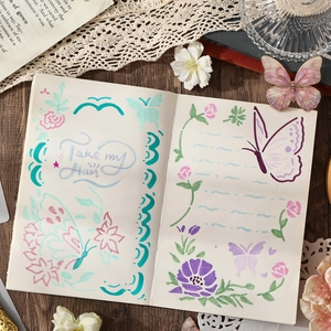 DIY journal stencil set featuring butterfly and floral patterns on vintage wood desk