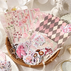 Vintage floral and butterfly scrapbook DIY kit with 100 sheets in a rustic setting