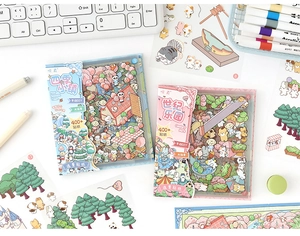 Flat lay of colorful DIY sticker boxes for journaling featuring cartoon nature elements