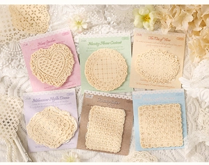Flat lay of vintage lace hollow decorative paper stickers with floral and heart patterns