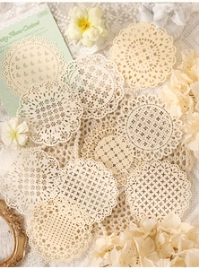Detailed macro view of cream lace paper doilies for vintage scrapbooking decoration