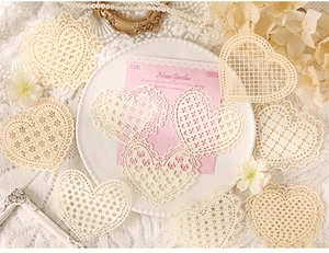 Detail of heart-shaped hollow lace doilies for scrapbooking and vintage decor