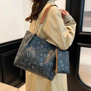 Large black letter print tote bag with brown leather strap and chain detail for women