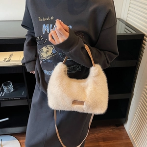 Chic beige plush tote bag with long fur and brown leather strap for autumn fashion