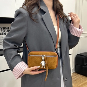 Retro faux suede crossbody bag with metal robot pendant and adjustable leather shoulder strap
