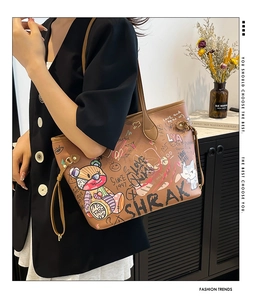 Detail of caramel brown leather tote bag featuring vibrant street style cartoon graffiti