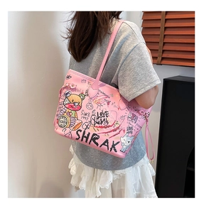 Shoulder shot of pink tote bag with colorful cartoon graffiti and artistic lettering