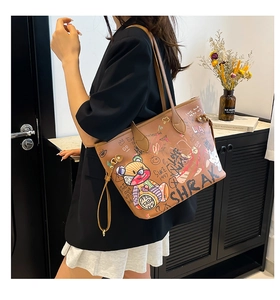 Detail shot of the large tote bag showing colorful cartoon graffiti and artistic patterns