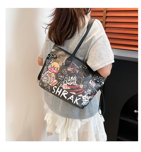 Detailed back view of a black graffiti tote bag with cartoon bear and street art prints