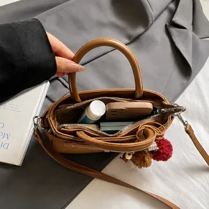 Brown matte handbag interior view showing storage capacity for phone and essentials