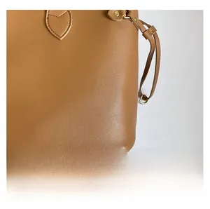 Detail of lychee pattern leather handbag with gold rivets and fine stitching work