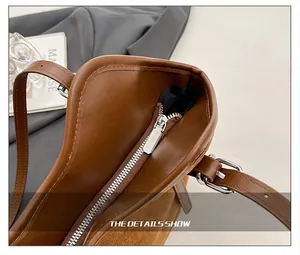 Detail of vintage brown tote featuring smooth leather suede splicing and silver zipper