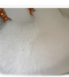 Detail of white faux fur handbag texture with orange beaded shoulder strap close-up