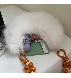 Detail view of white fuzzy plush bag showing spacious interior with beads strap