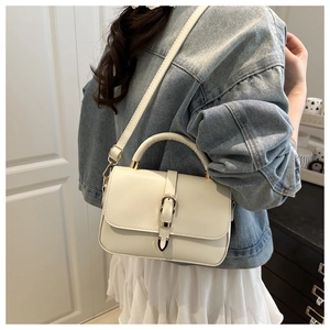 Side view of cream-white leather handbag with adjustable strap for casual daily use