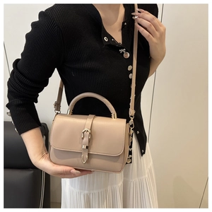 Beige small square bag featuring a golden metal buckle with a top handle and shoulder strap