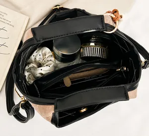 Top view of bucket bag showing large interior capacity with zipper pocket and accessories
