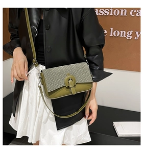 Detail of retro crossbody bag with olive green leather and woven straw textures