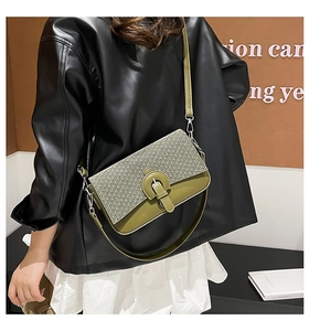 Detail of green and beige quilted flap bag with metallic buckle and shoulder strap